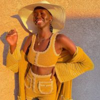 Adut akech smiling wearing yellow