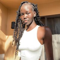 Adut akech wearing white tanktop