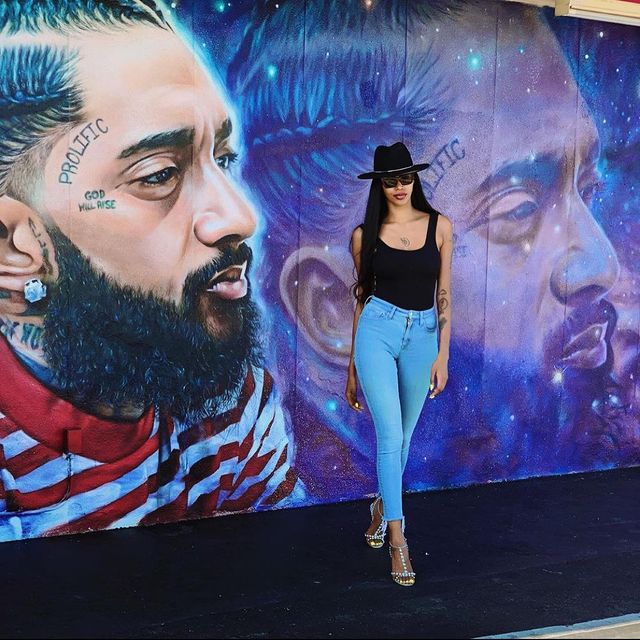 Jessica white in la next to nipsey hussle wall