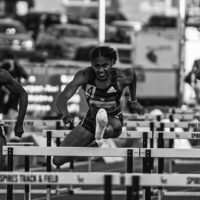 Christina Clemons jumping hurdles