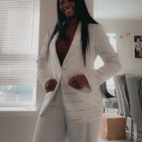 Claressa Shields smiling in white suit