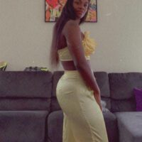 Claressa Shields wearing yellow outfit in living room