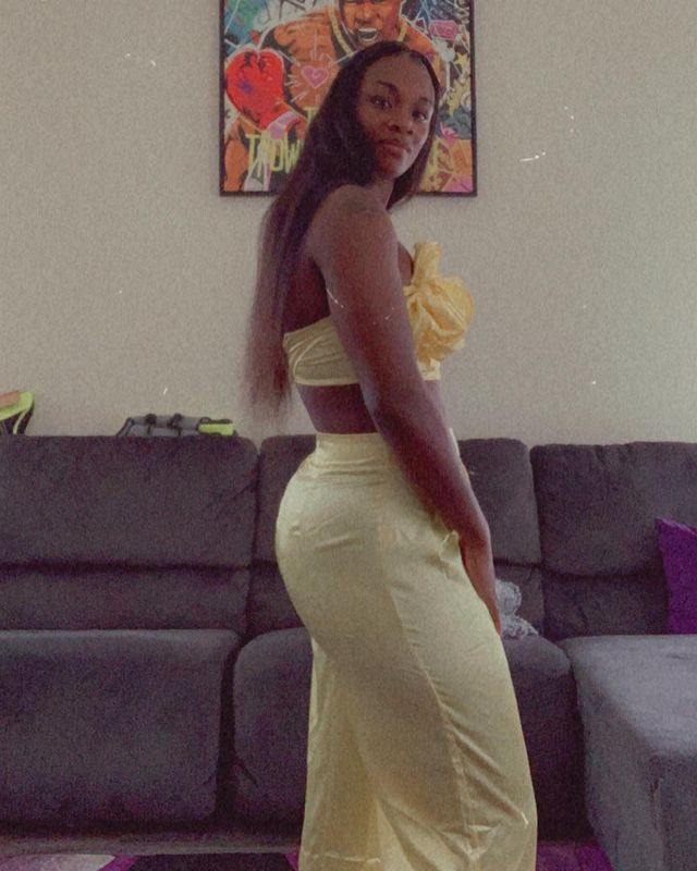 Claressa Shields wearing yellow outfit in living room