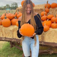 Gabby Thomas with pumpkin