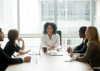 A diverse board of directors sitting around a table