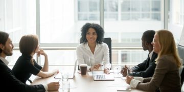 A diverse board of directors sitting around a table