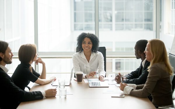 A diverse board of directors sitting around a table