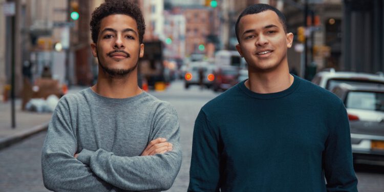 two black college students looking confident city street background