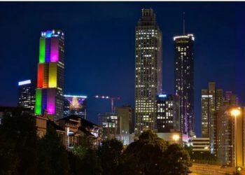 skyscraper lit up with pride colors