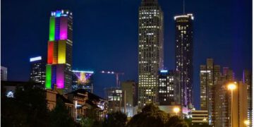 skyscraper lit up with pride colors