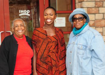 Adenah Bayo pictured in the middle with two other women in front of a IHOP.