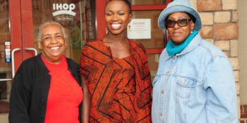 Adenah Bayo pictured in the middle with two other women in front of a IHOP.