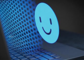 computer screen with a large happy face