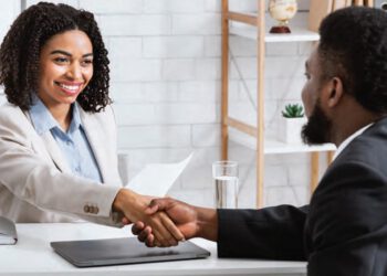 hiring manager shaking hands with new hire