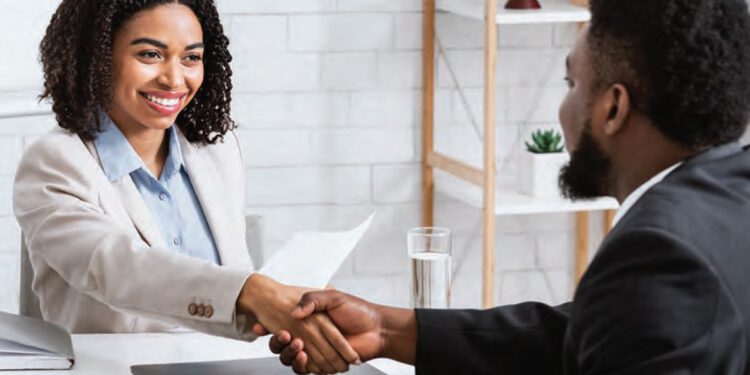 hiring manager shaking hands with new hire