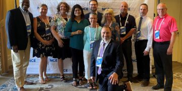 attendees pictured in small group at the Arc conference in NY