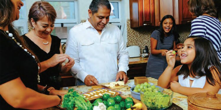 family enjoying preparing a meal together