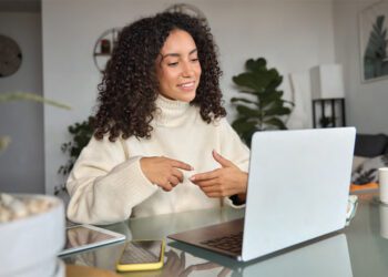 woman at home office desk speaking online