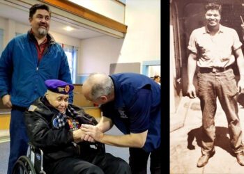 Solomon Atkinson, a pioneering Navy SEAL in wheelchair at ceremony with young self pictured on the side