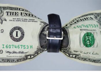 Dollar bill with belt tight around it