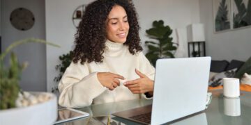 woman at home office desk speaking online