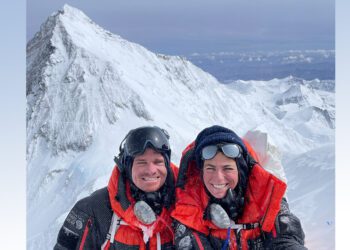 Unger and Lehmann posing on mountain in climbing gear smiling