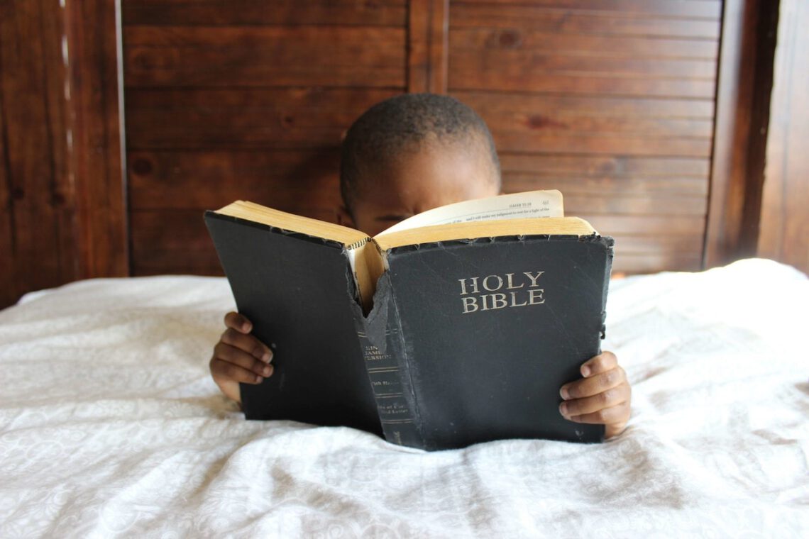 Young Black Boy Reading A Bible