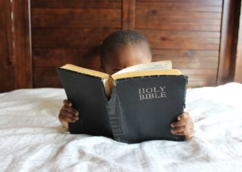 Young Black Boy Reading A Bible