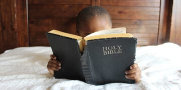 Young Black Boy Reading A Bible