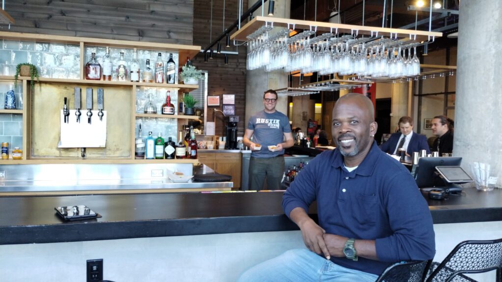 Rustik Taverns Owner Frantz Metellus Poses In Front Of The Restaurants Bar. Photo Credit_ Karen Juan.jpeg