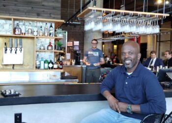 Rustik Taverns Owner Frantz Metellus Poses In Front Of The Restaurants Bar. Photo Credit_ Karen Juan.jpeg