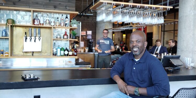 Rustik Taverns Owner Frantz Metellus Poses In Front Of The Restaurants Bar. Photo Credit_ Karen Juan.jpeg